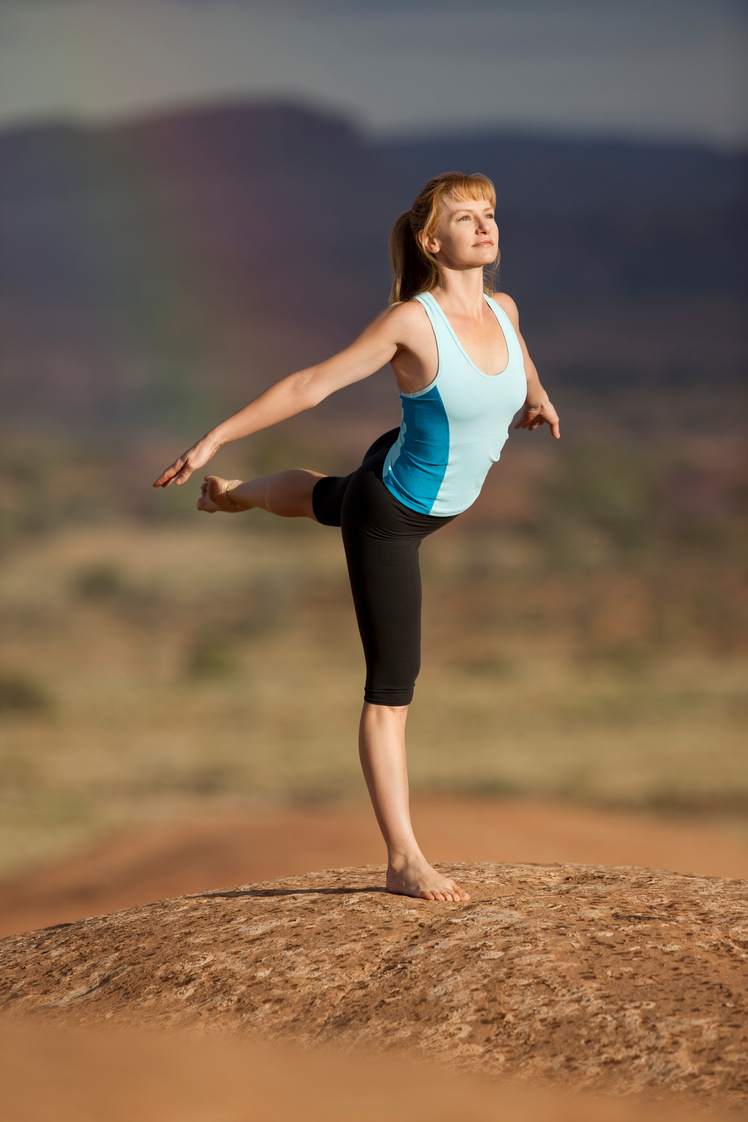 Woman Outdoors In Warrior III Yoga Position